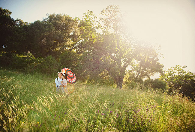couple with umbrella in field engagement photos